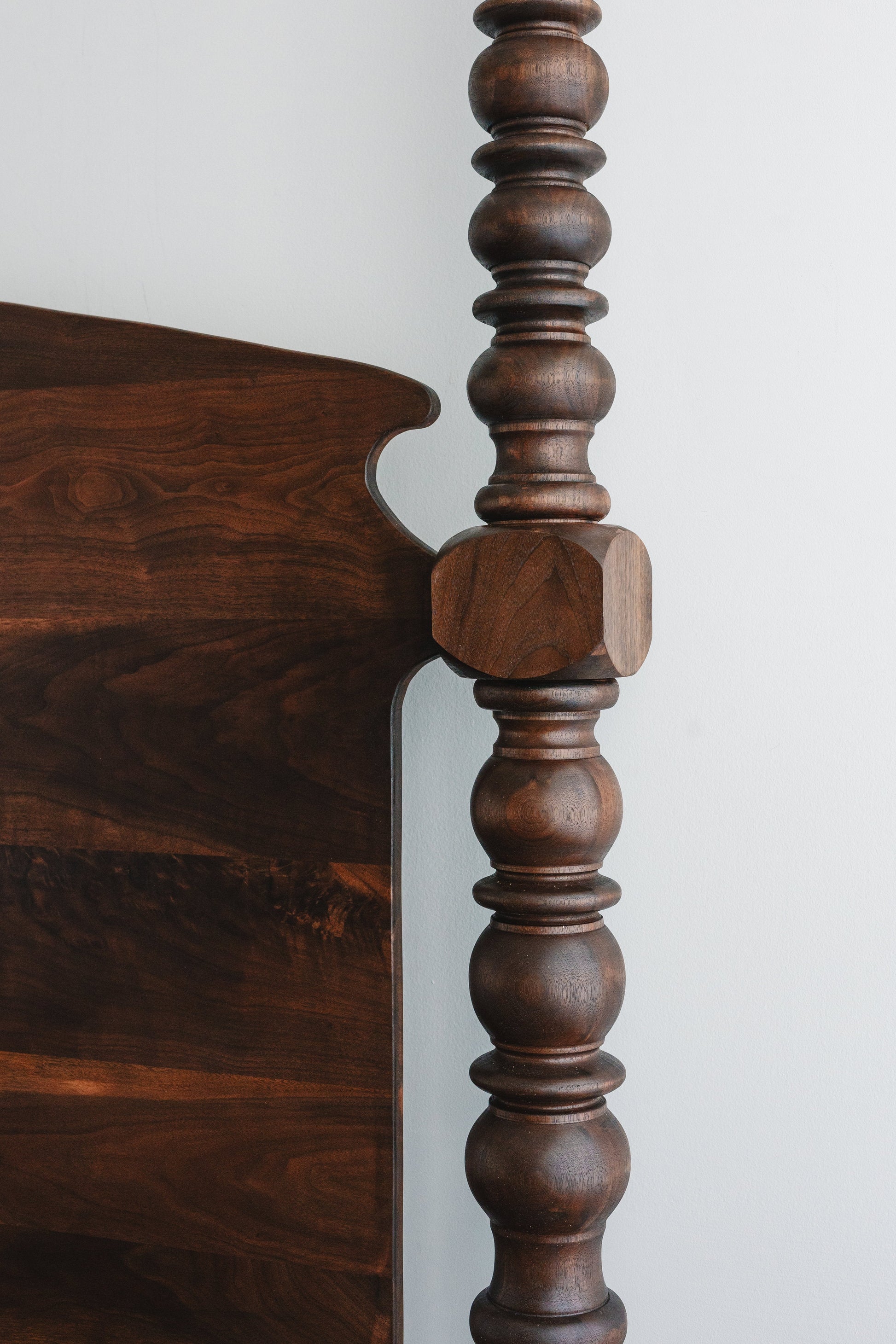Hand-lathed black walnut poster on The Prince bed
