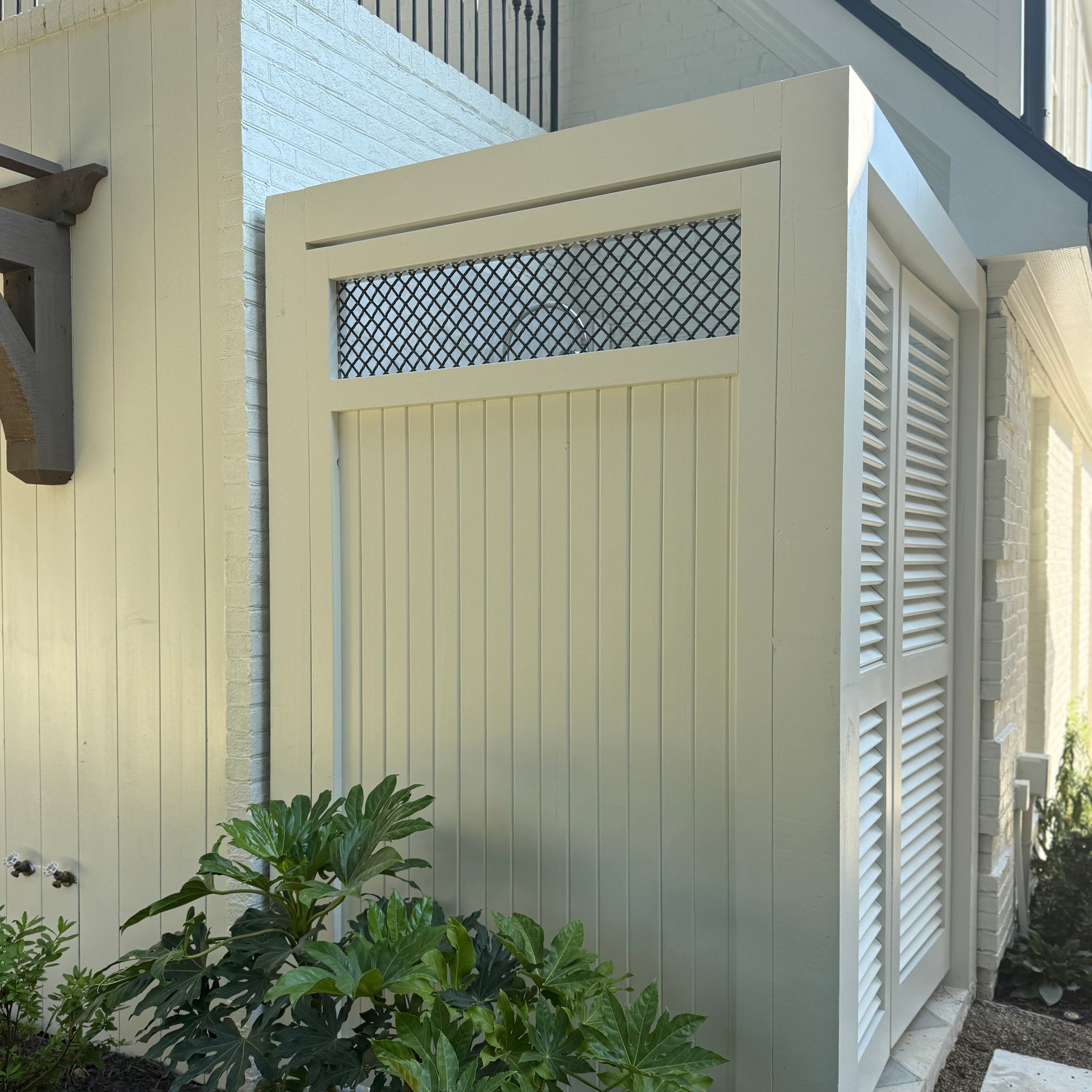 Custom outdoor shower with painted eastern red cedar saloon doors in Atlanta GA by Reviving Dawn