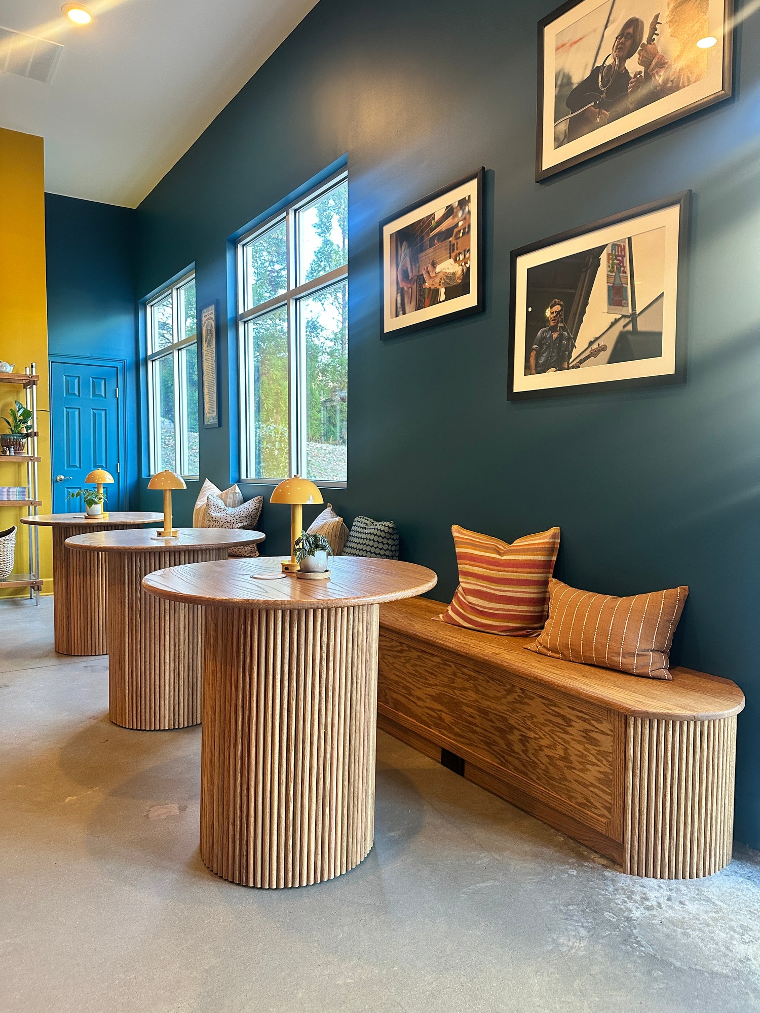 Custom commercial millwork with three tambour tables and built-in banquette by Reviving Dawn