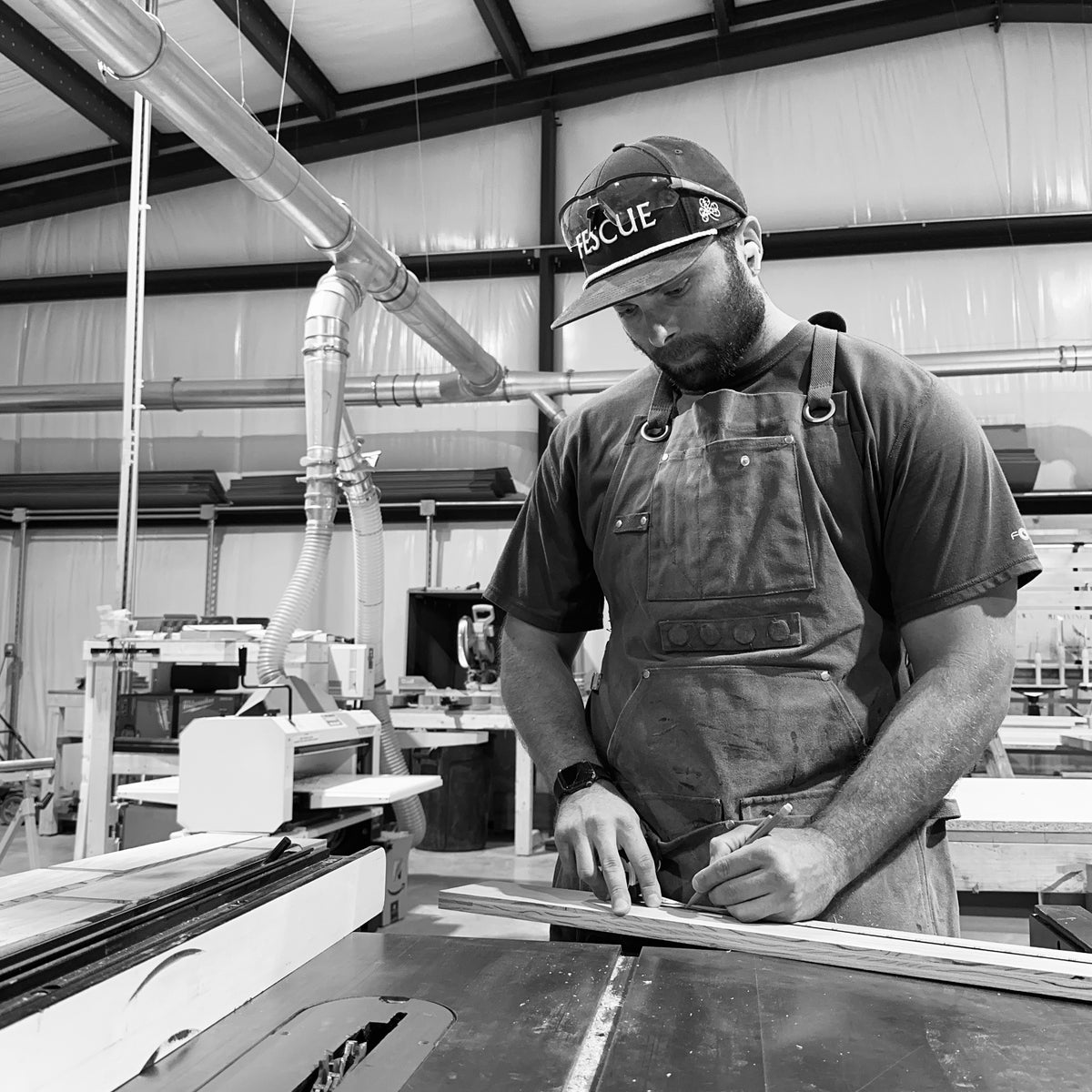 Kyle Oliver at the table saw in the Reviving Dawn shop in Watkinsville, Georgia