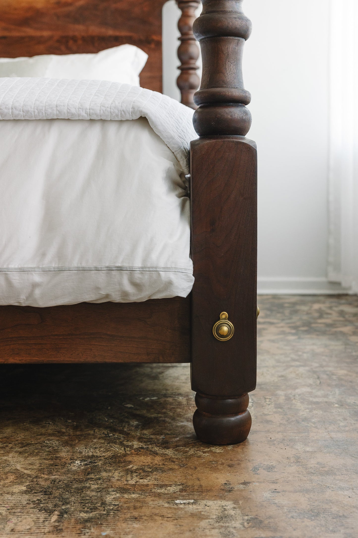 Black walnut four poster bed with brass bed bolt covers