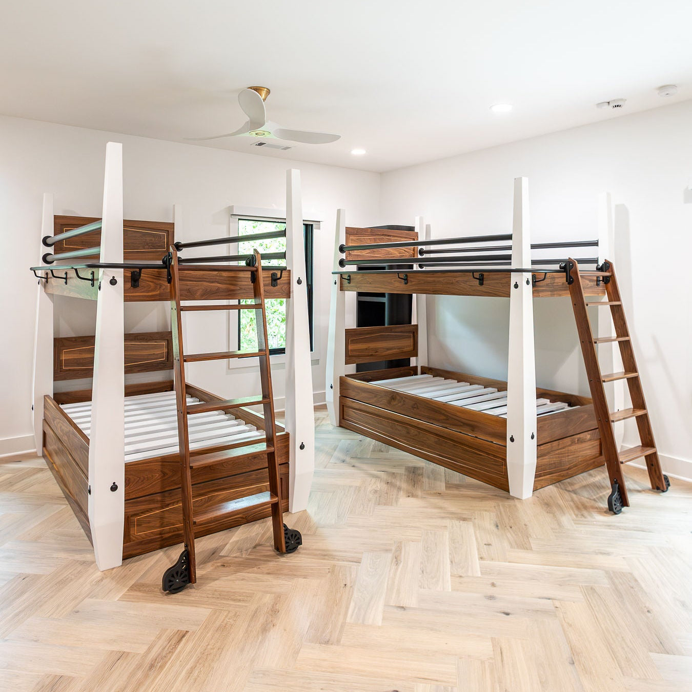 Finished custom walnut bunk beds with copper inlay and library ladders